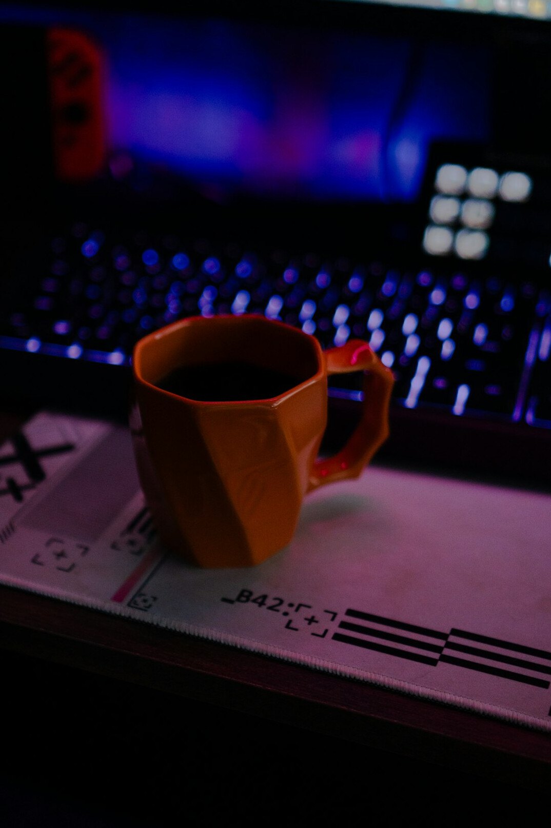 Laptop and notebook on a dark desk